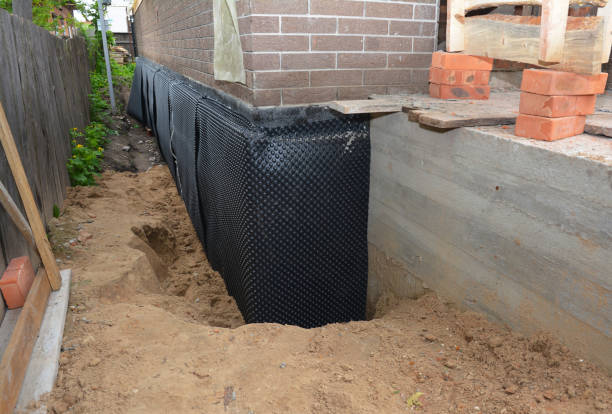 SJ Waterproofing Pros technician performing targeted Wet Basement Repair assessment in Vandalia, OH